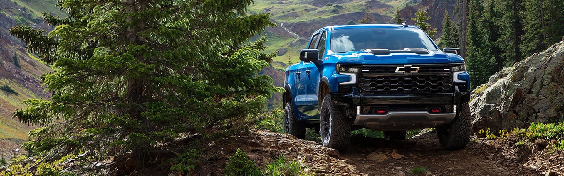 A 2021 Chevrolet Silverado navigating a rugged rocky trail.