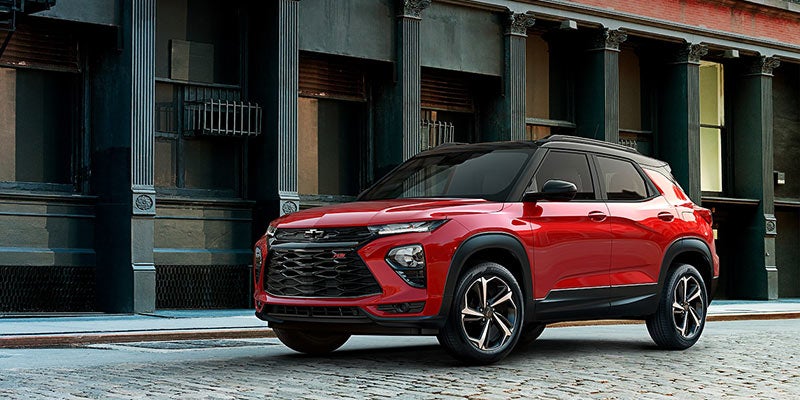 Red Trailblazer Parked on a Road in Front of a Building